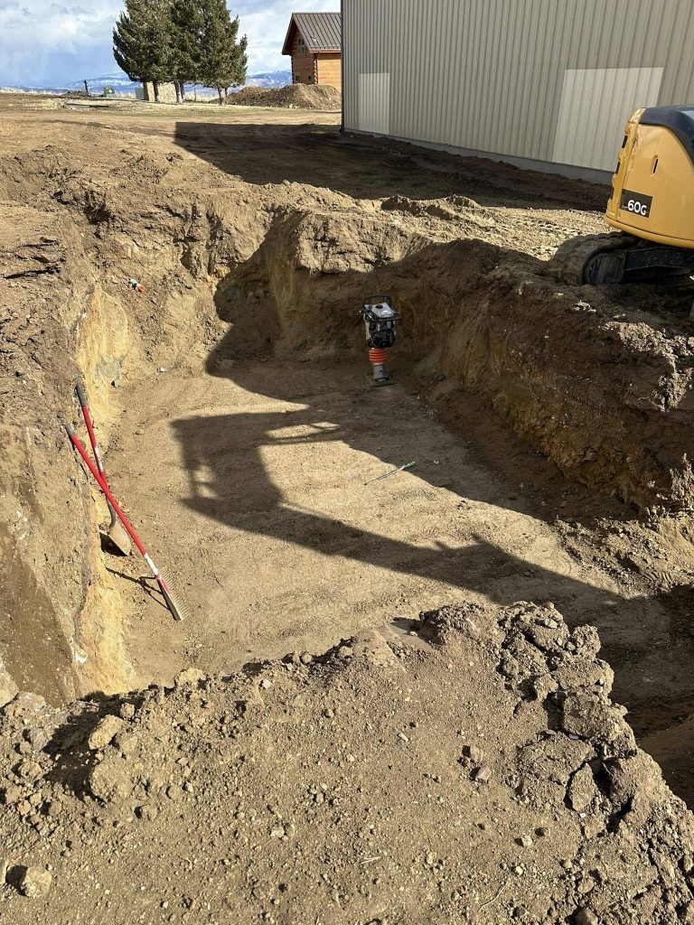 Excavated trench for foundation and utility installation in Whitehall MT construction site