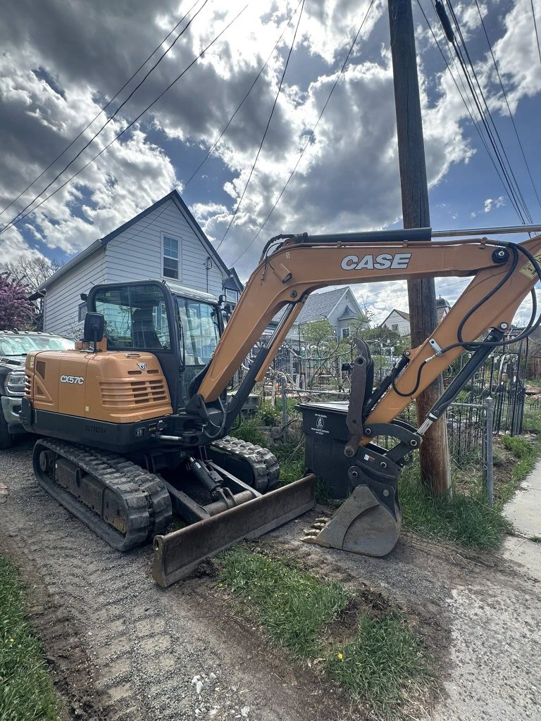 CASE CX75C excavator parked beside Helena MT home on residential excavation project